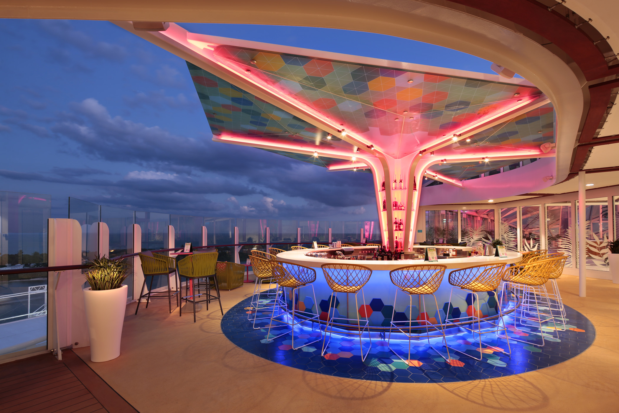 Enjoy a cocktail in The Vue Bar - the bar has a colourful mosaic canopy overhead after sunset