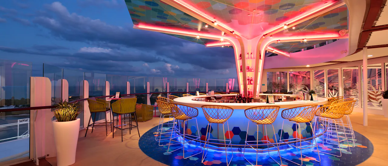 Enjoy a cocktail in The Vue Bar - the bar has a colourful mosaic canopy overhead after sunset