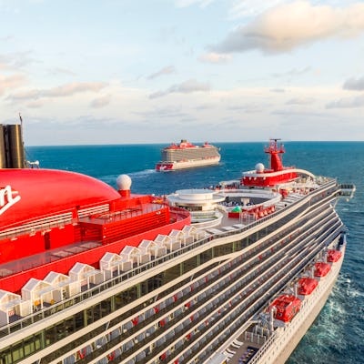 Two Virgin Voyages ships, Scarlet Lady and Valiant Lady, at sea