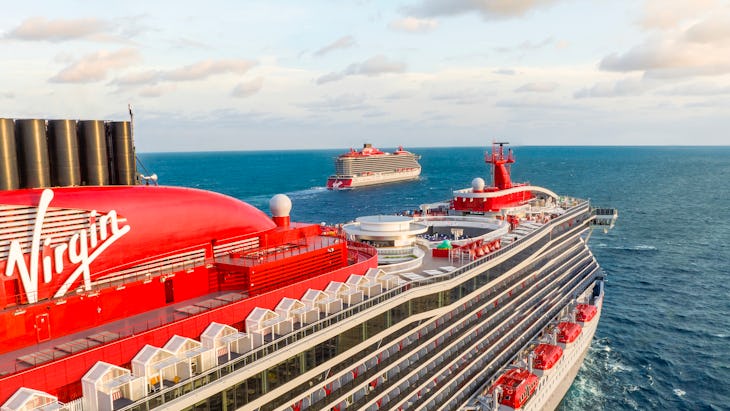 Two Virgin Voyages ships, Scarlet Lady and Valiant Lady, at sea