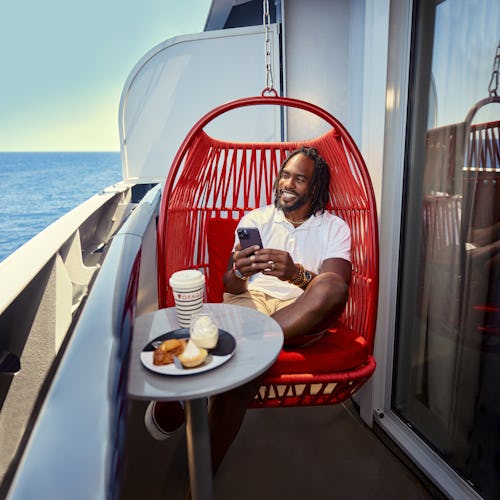 A man gazes out to sea in a Sea Terrace cabin