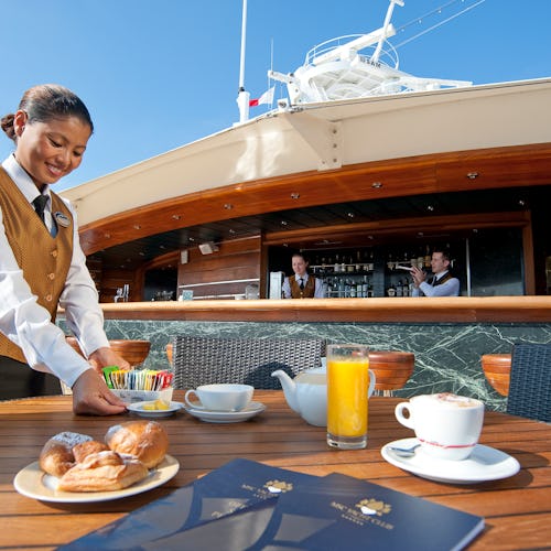 A MSC Cruises staff member serving breakfast
