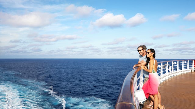 Couple on a Carnival cruise looking out to sea
