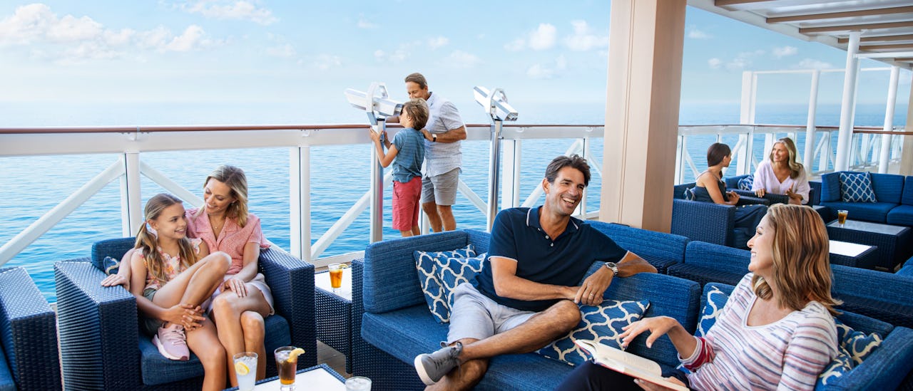 Guests in the Norwegian Encore waterfront lounge