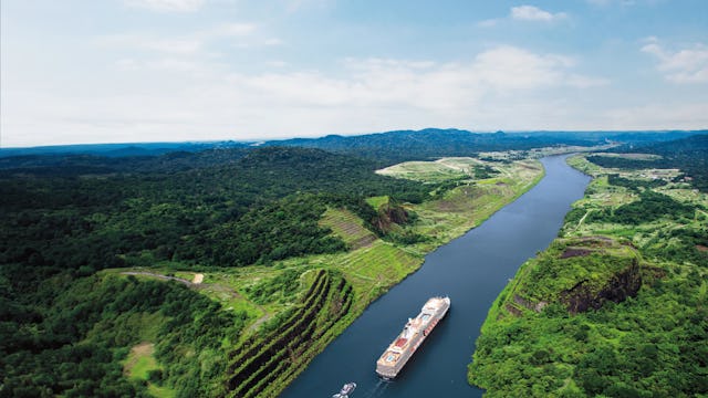 A Holland America Line ship sailing down the Panama Canal