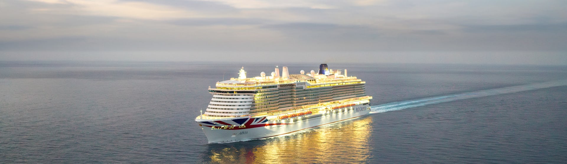 Arvia lit up at sunset at sea