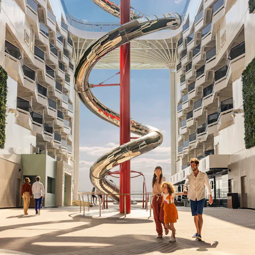 Family in front of venom drop slide on MSC World Europa