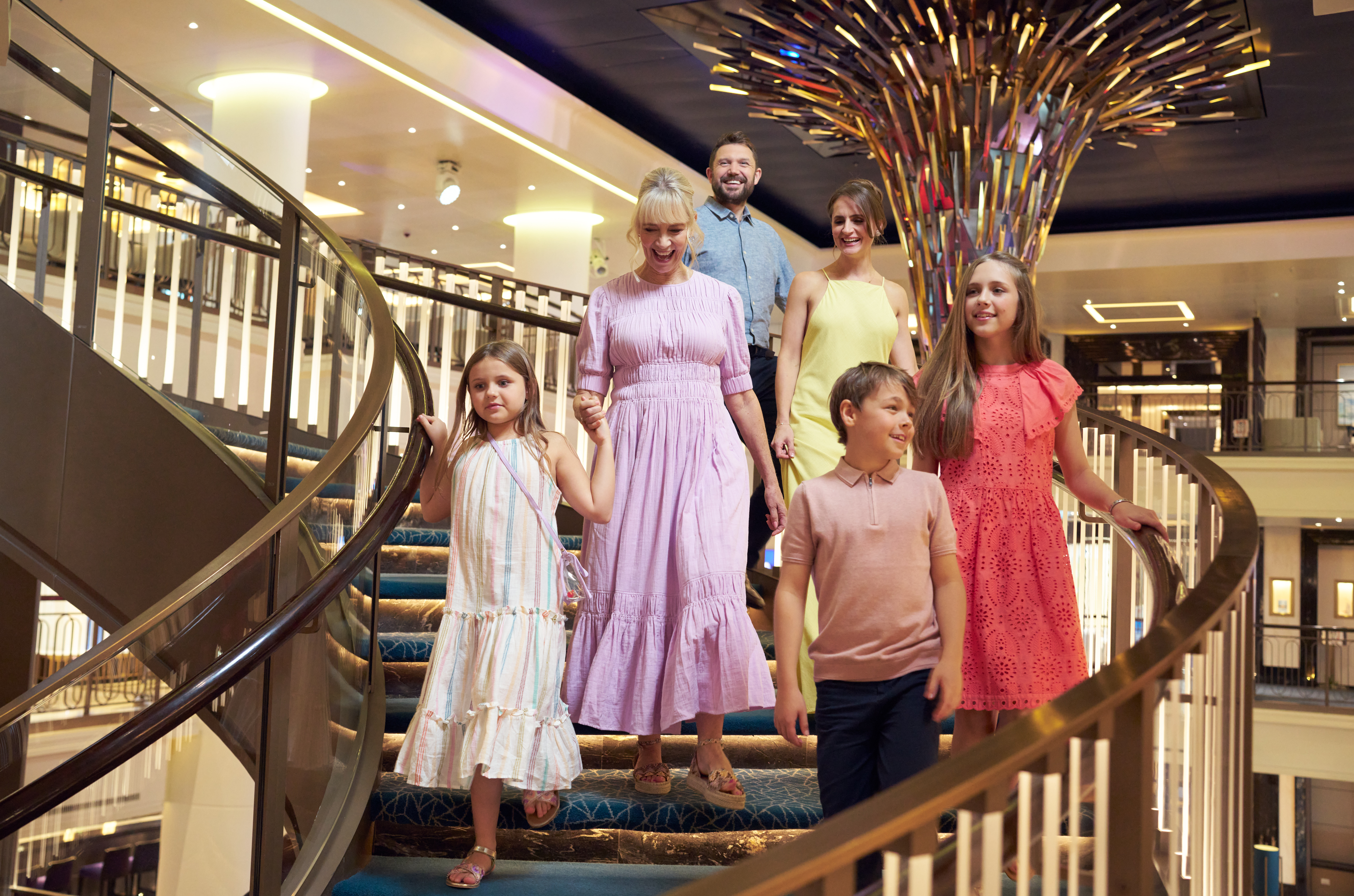 Family walking down atrium stairs on P&O ship