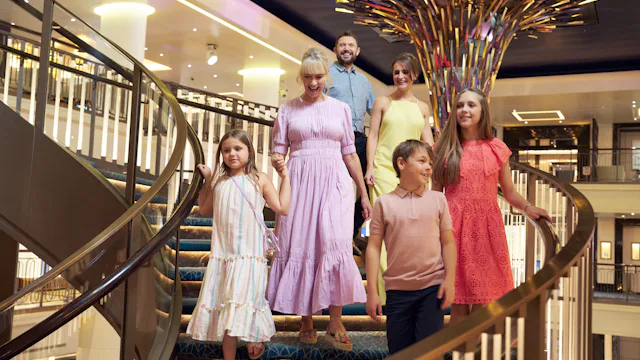 Family walking down atrium stairs on P&O ship