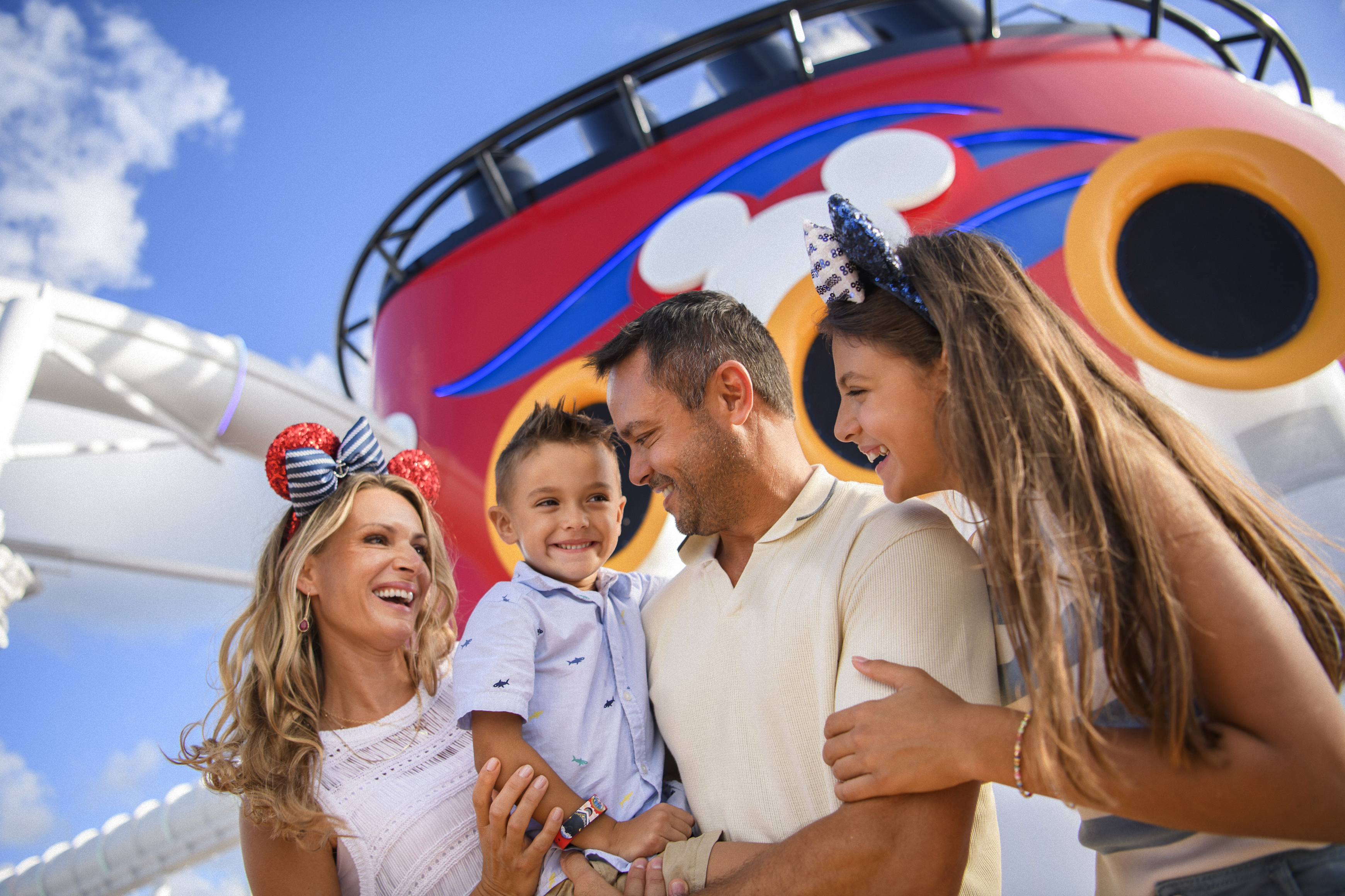 Family on Disney ship with funnel in the background