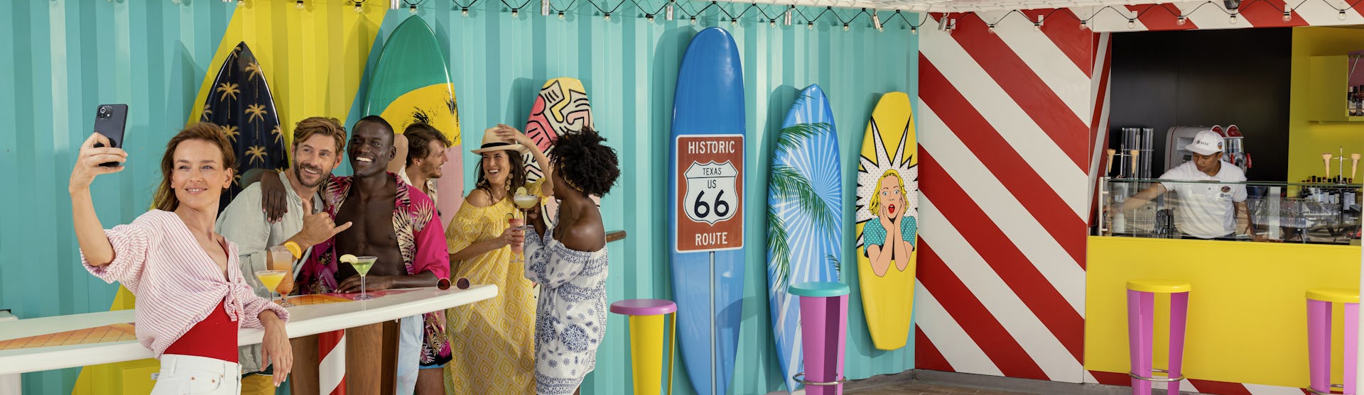 People taking a selfie in a tropical bar onboard a Royal Caribbean ship