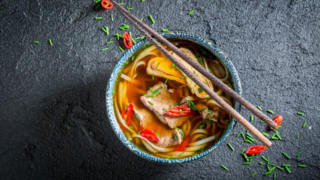 bowl of noodles with chopsticks on top