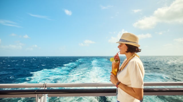 Woman with cocktail at aft of Virgin Voyages ship
