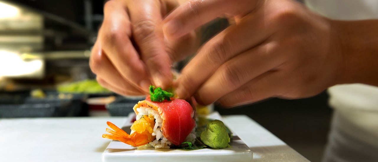 A chef preparing sushi on a Royal Caribbean ship